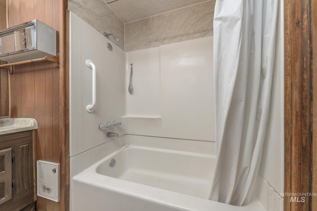 bathroom featuring wooden walls, shower / bath combo, and vanity