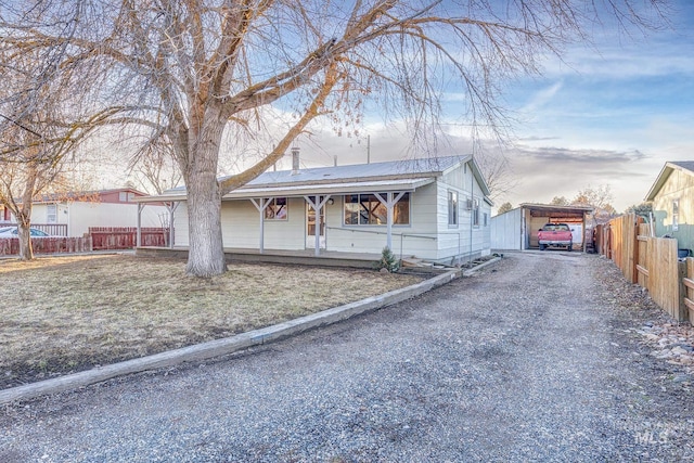 view of front of home featuring a carport and covered porch