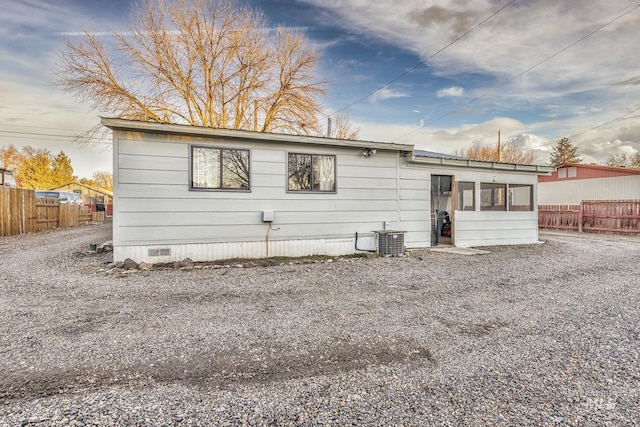 back of house featuring central AC unit