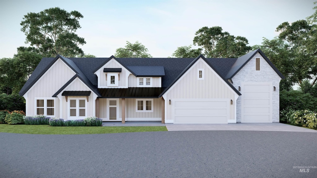 modern farmhouse featuring driveway, an attached garage, stone siding, board and batten siding, and metal roof