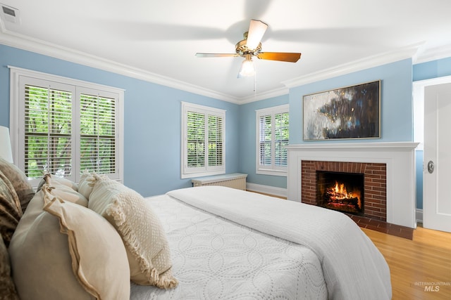1312 E Warm Springs Ave, Boise, ID 83712 - bedroom with wood finished floors, ornamental molding, a fireplace, and a ceiling fan
