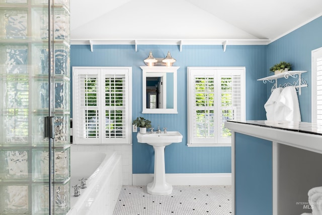 1312 E Warm Springs Ave, Boise, ID 83712 - full bathroom featuring a garden tub, lofted ceiling, baseboards, and tile patterned flooring