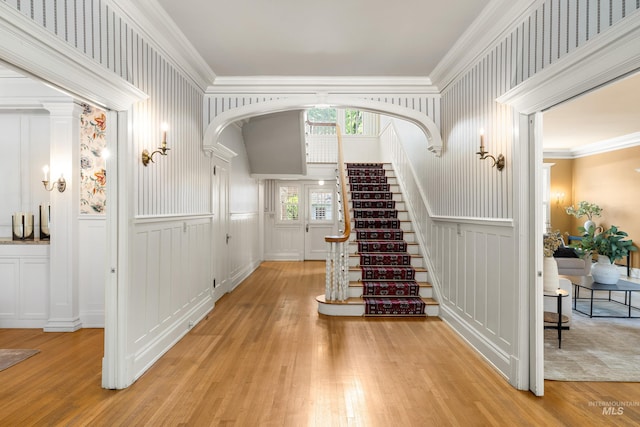 1312 E Warm Springs Ave, Boise, ID 83712 - stairs with a decorative wall, arched walkways, wood finished floors, crown molding, and a wainscoted wall