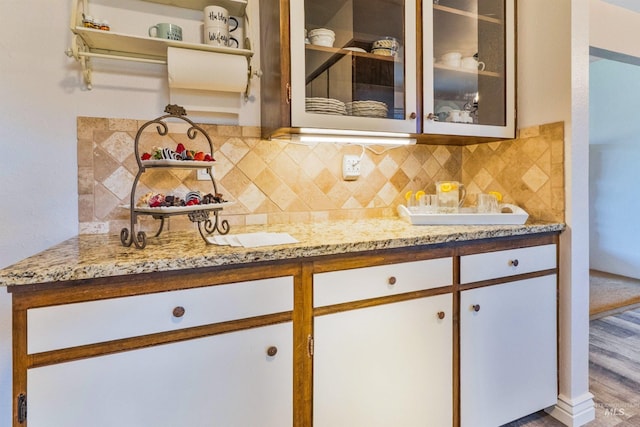 bar area featuring decorative backsplash and wood finished floors