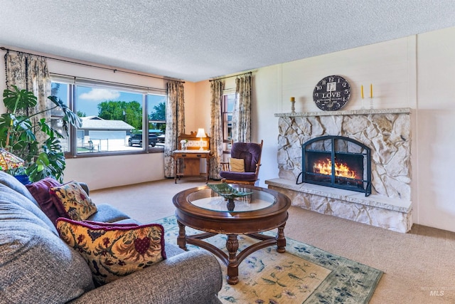 living room featuring carpet, a textured ceiling, and a fireplace