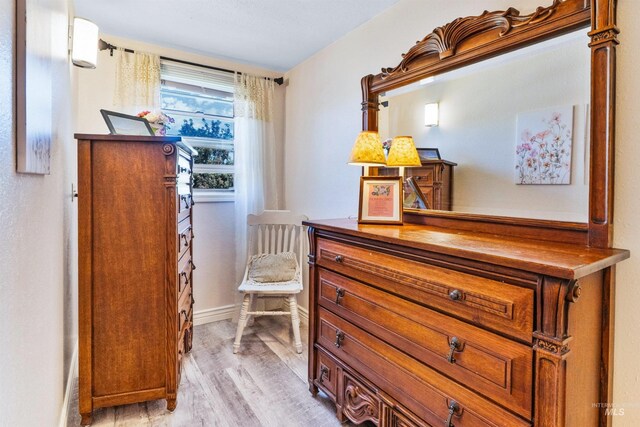 sitting room featuring light wood-type flooring and baseboards