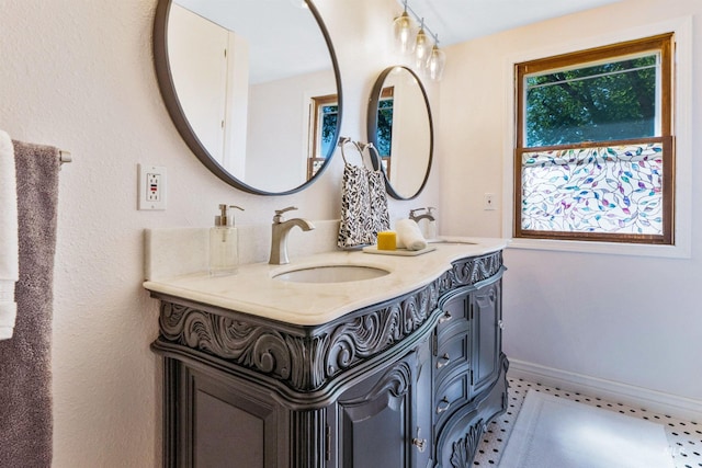full bathroom featuring double vanity and baseboards