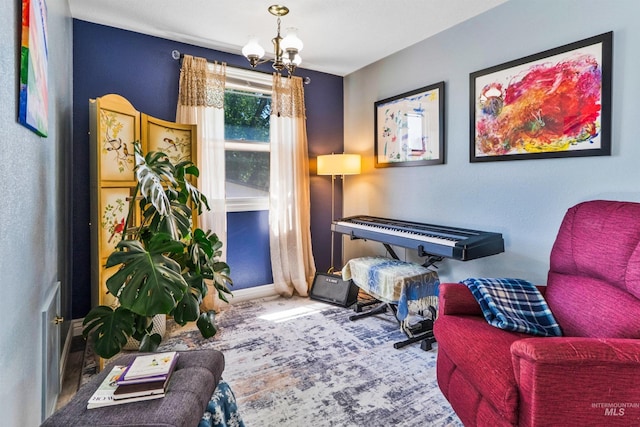 sitting room featuring a chandelier, carpet floors, and baseboards