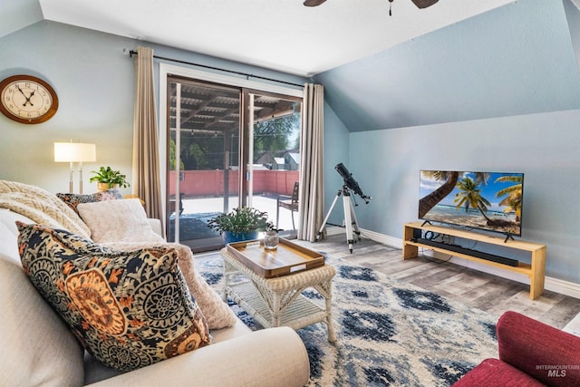 living area with vaulted ceiling, baseboards, a ceiling fan, and wood finished floors
