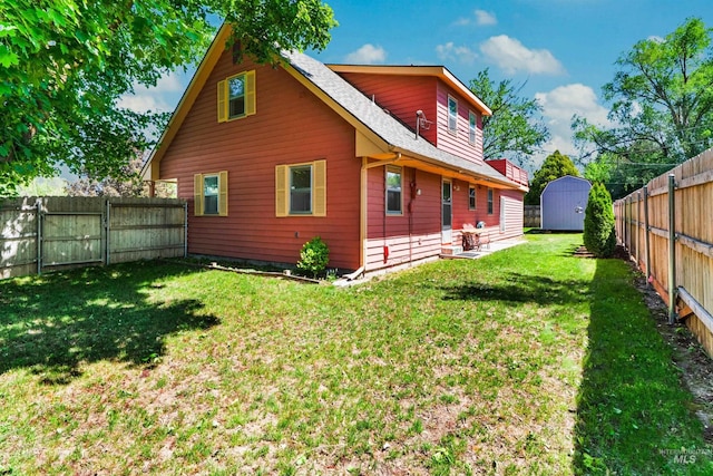 rear view of property featuring a shed, an outdoor structure, a gate, and roof with shingles