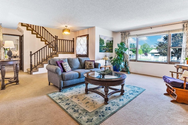 living area with carpet flooring, stairway, and a textured ceiling
