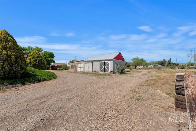 764 NW Beaman St, Mountain Home, ID 83647 - view of dirt / gravel driveway with a barn