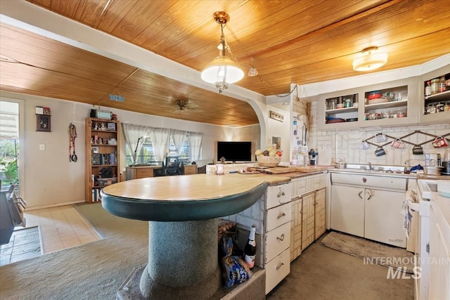 764 NW Beaman St, Mountain Home, ID 83647 - kitchen featuring wood ceiling, a peninsula, open shelves, light countertops, and light colored carpet