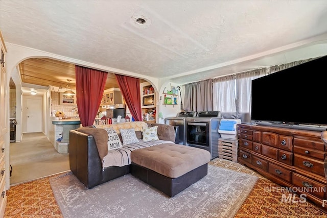 764 NW Beaman St, Mountain Home, ID 83647 - living room with arched walkways, washer / clothes dryer, and a textured ceiling