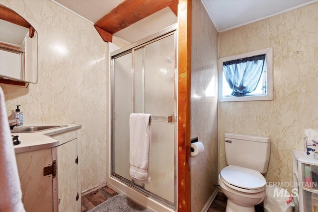 764 NW Beaman St, Mountain Home, ID 83647 - bathroom featuring vanity, wood finished floors, a stall shower, toilet, and crown molding