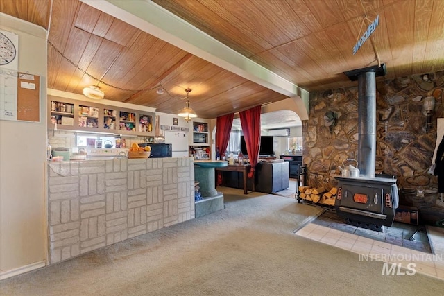 764 NW Beaman St, Mountain Home, ID 83647 - carpeted living room with wooden ceiling, a wood stove, a bar, and arched walkways