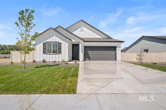 view of front of home with fence, board and batten siding, concrete driveway, a front yard, and a garage