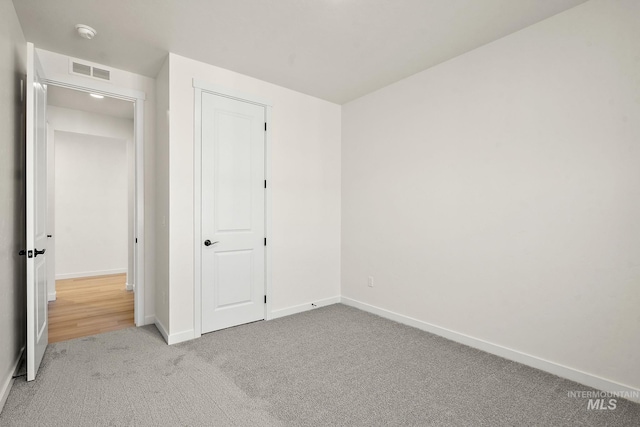 unfurnished bedroom featuring visible vents, baseboards, and carpet flooring