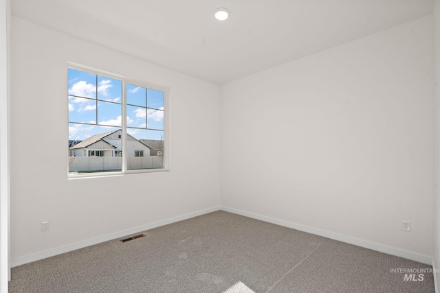 empty room with recessed lighting, carpet flooring, baseboards, and visible vents