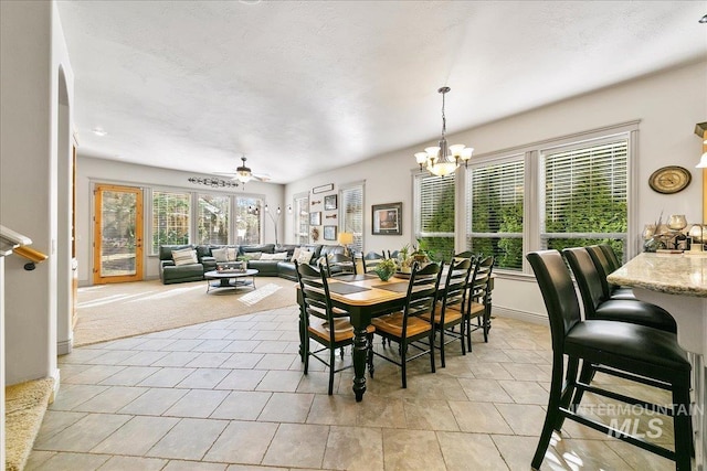 dining area featuring baseboards and an inviting chandelier