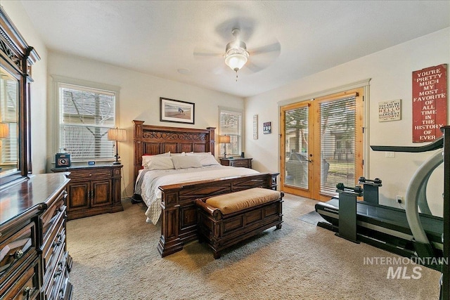 bedroom with multiple windows, light carpet, french doors, and access to exterior