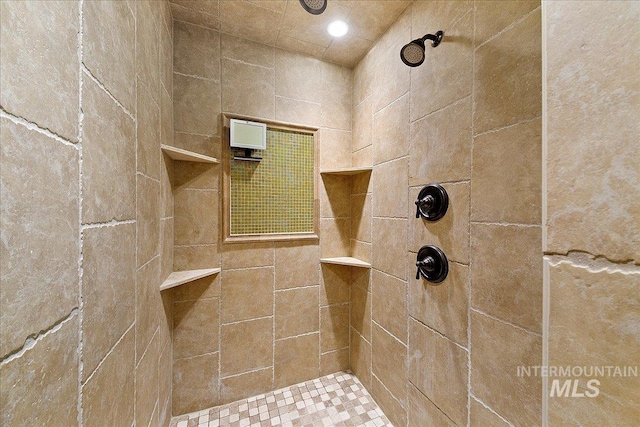bathroom with a tile shower