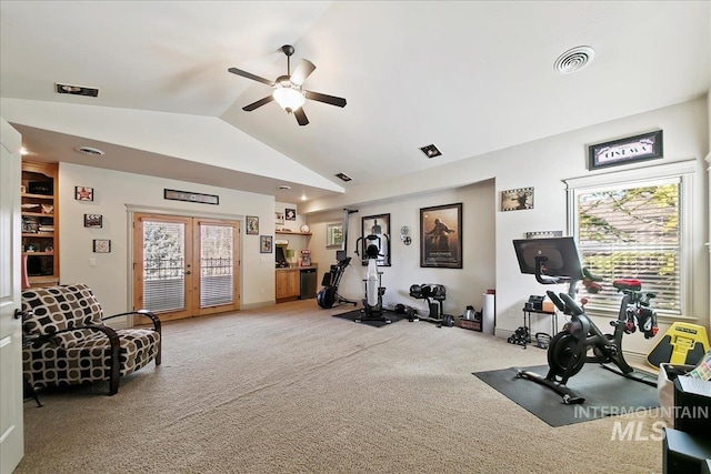 exercise area with a ceiling fan, a wealth of natural light, visible vents, light colored carpet, and lofted ceiling
