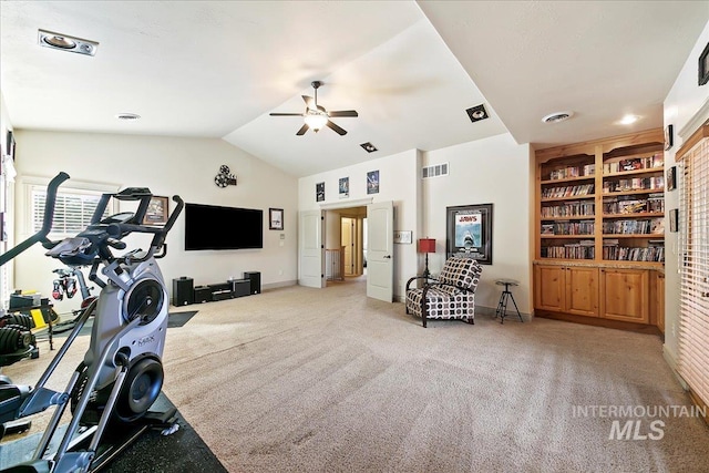 workout room featuring light colored carpet, visible vents, built in shelves, and a ceiling fan