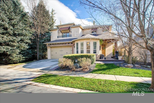 traditional-style home with stone siding, a balcony, concrete driveway, a garage, and stucco siding