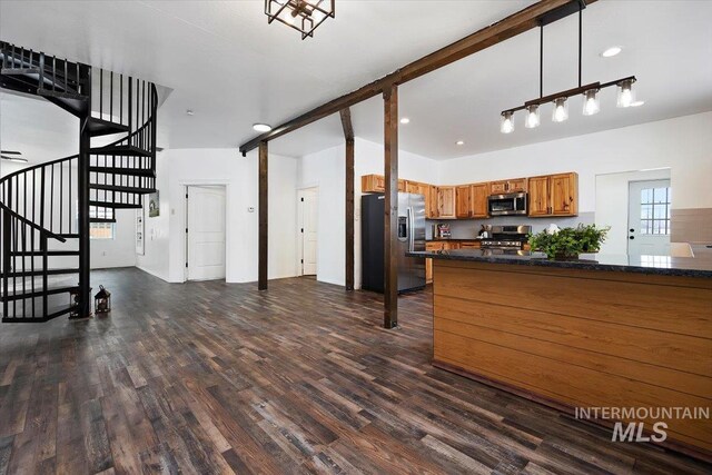341 Birch St S, Kimberly, ID 83341 - kitchen with appliances with stainless steel finishes, brown cabinetry, dark wood finished floors, decorative light fixtures, and dark stone countertops