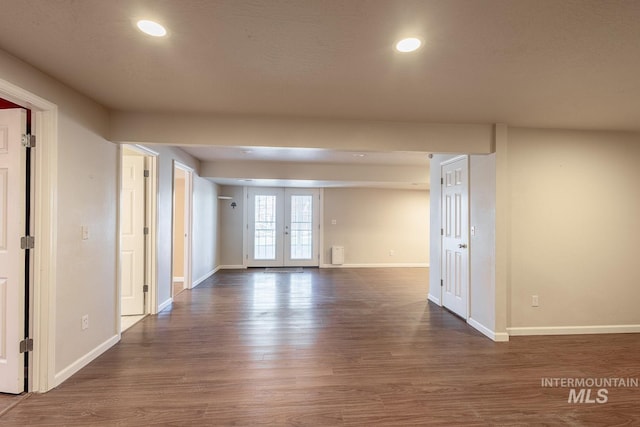 spare room featuring recessed lighting, baseboards, wood finished floors, and french doors