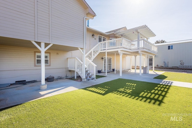 back of property featuring a patio area, stairs, a lawn, and a pergola