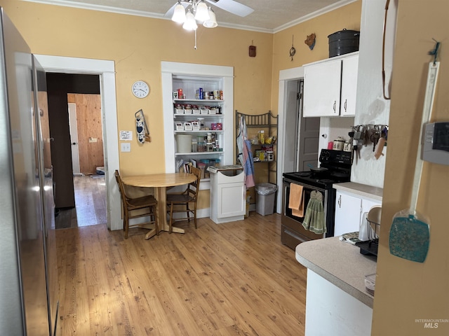 145 N Lincoln, Oakley, ID 83346 - kitchen with black electric range, light wood-style flooring, white cabinets, and ornamental molding