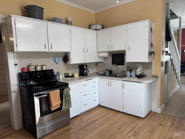 145 N Lincoln, Oakley, ID 83346 - kitchen featuring crown molding, stainless steel range with electric stovetop, light countertops, and a sink