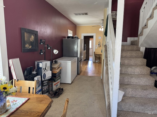 145 N Lincoln, Oakley, ID 83346 - kitchen featuring visible vents, ceiling fan, light colored carpet, light countertops, and freestanding refrigerator