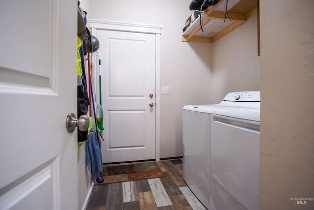 laundry area with independent washer and dryer and dark hardwood / wood-style floors