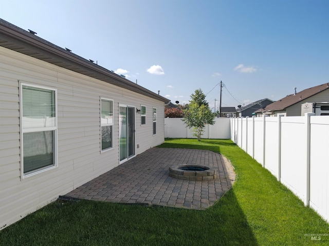 view of yard with an outdoor fire pit and a patio area