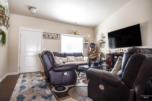 living room with vaulted ceiling and dark hardwood / wood-style floors