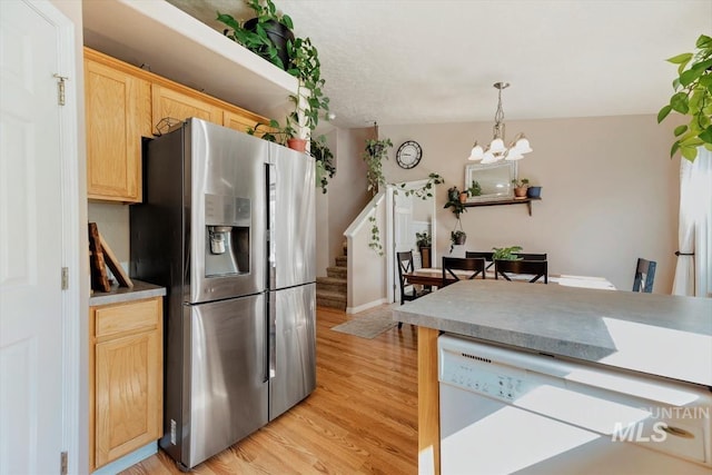 kitchen with stainless steel fridge, light wood-style flooring, white dishwasher, light brown cabinetry, and a chandelier