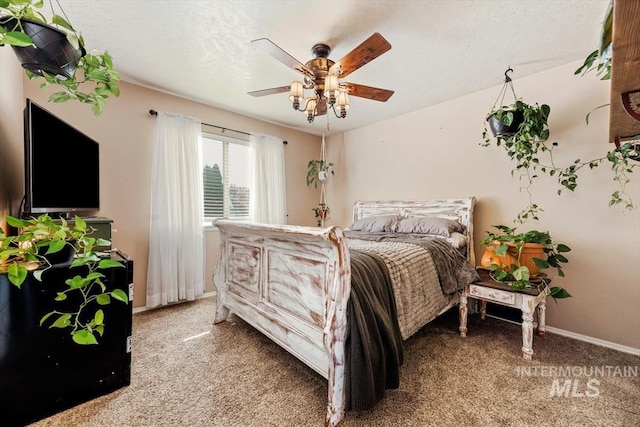 bedroom with light colored carpet, ceiling fan, a textured ceiling, and baseboards