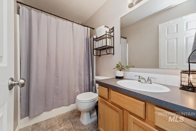 bathroom featuring toilet and vanity