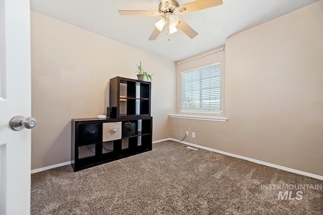 interior space with carpet floors, ceiling fan, and baseboards