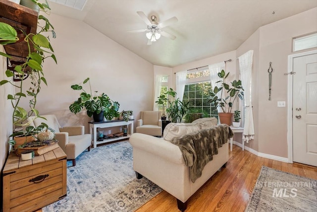 sitting room featuring lofted ceiling, visible vents, a ceiling fan, baseboards, and light wood finished floors