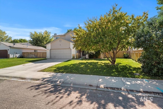 view of property hidden behind natural elements featuring an attached garage, driveway, a front yard, and fence