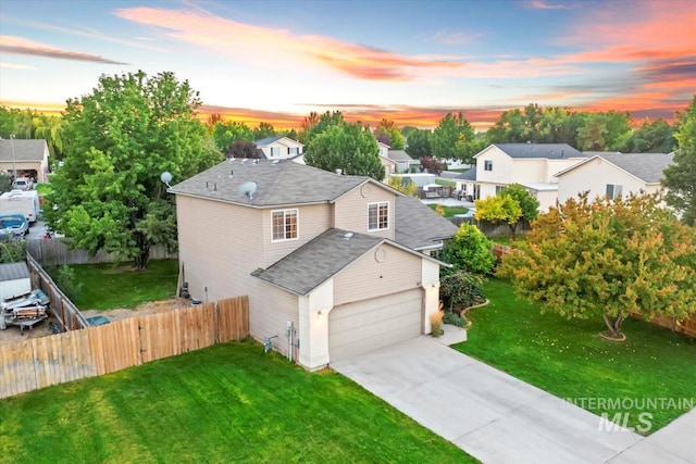 view of front of property featuring a garage, fence, a front lawn, and concrete driveway