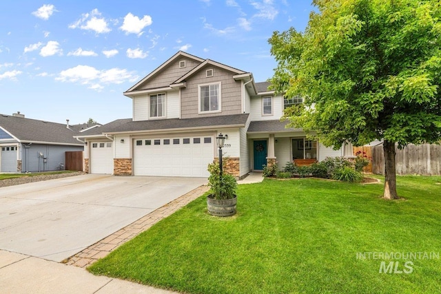 12339 W Foxhaven St, Star, ID 83669 - view of front facade featuring driveway, stone siding, and a garage