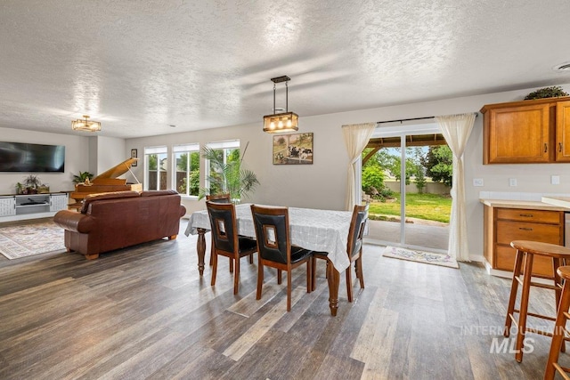 12339 W Foxhaven St, Star, ID 83669 - dining space with dark wood-style flooring and a textured ceiling