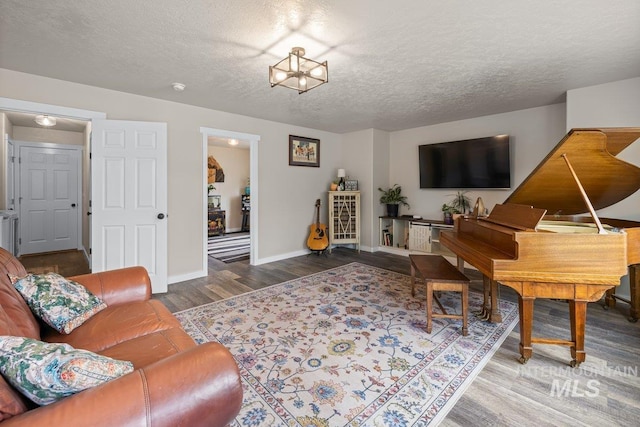 12339 W Foxhaven St, Star, ID 83669 - living area with wood finished floors, a textured ceiling, and a chandelier