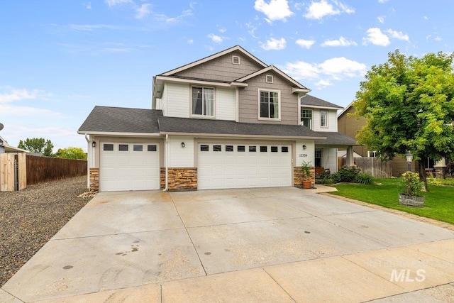 12339 W Foxhaven St, Star, ID 83669 - craftsman-style home featuring stone siding, concrete driveway, and an attached garage