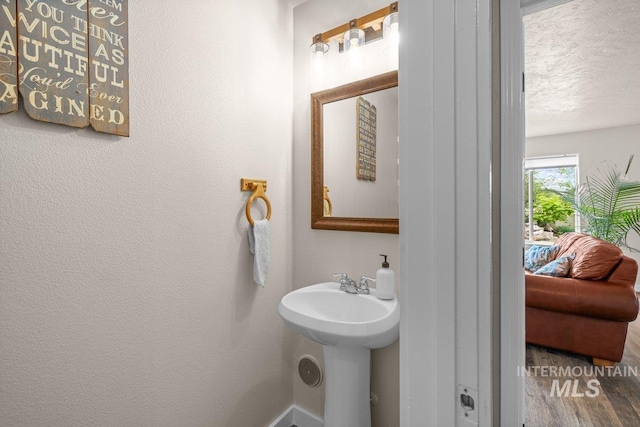 12339 W Foxhaven St, Star, ID 83669 - bathroom with a textured ceiling and wood finished floors